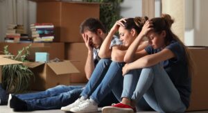 3 sad people with moving boxes