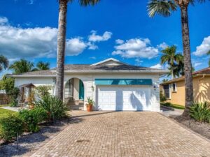Exterior of white, one level Naples house