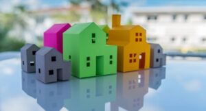 6 colorful toy houses on shiny blue tabletop