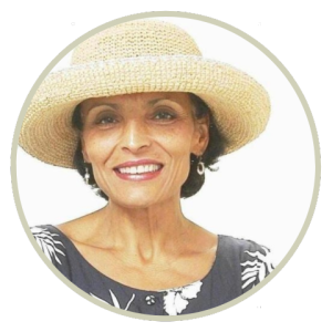 Ellie Penaranda wearing a straw hat and gray and floral shirt